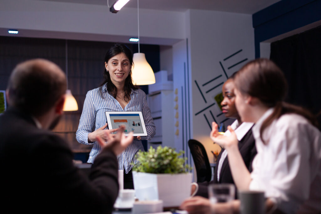 Overworked workaholic entrepreneur woman shwoing marketing graphs using tablet